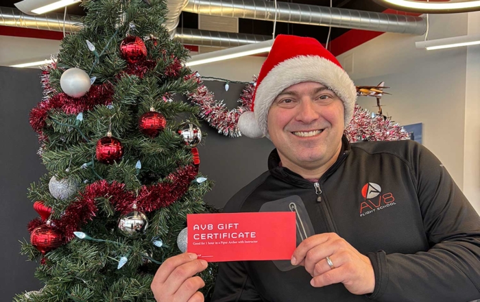 NIck in Santa Hat with AV8 Gift Certificate and holiday tree