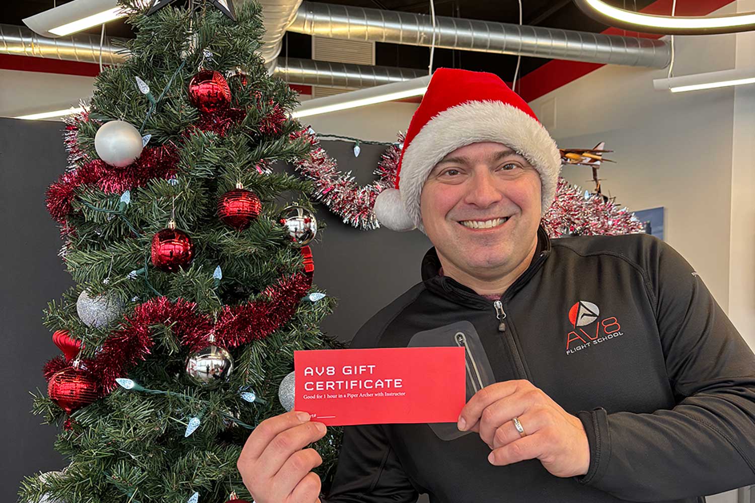 NIck in Santa Hat with AV8 Gift Certificate and holiday tree