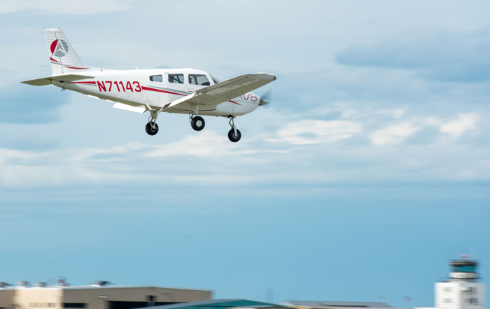 piper archer flying over airport