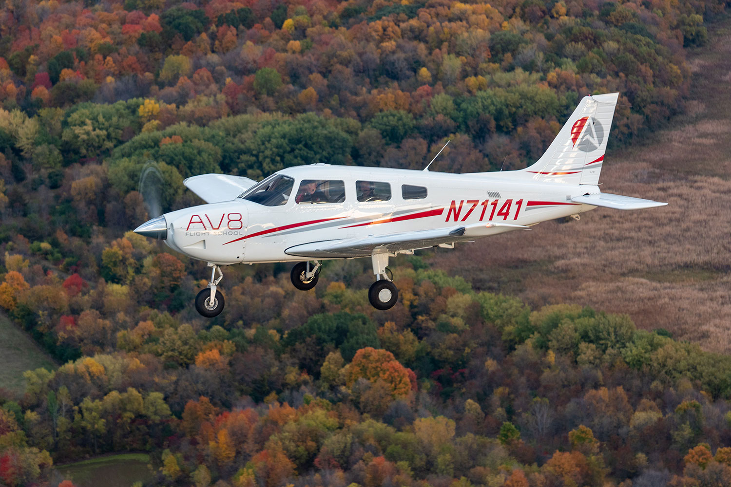 Archer-3-AV8-Flight-opt piper archer flying over wooded area